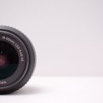 Detailed close-up shot of a Nikon AF-S DX NIKKOR lens on a white background.